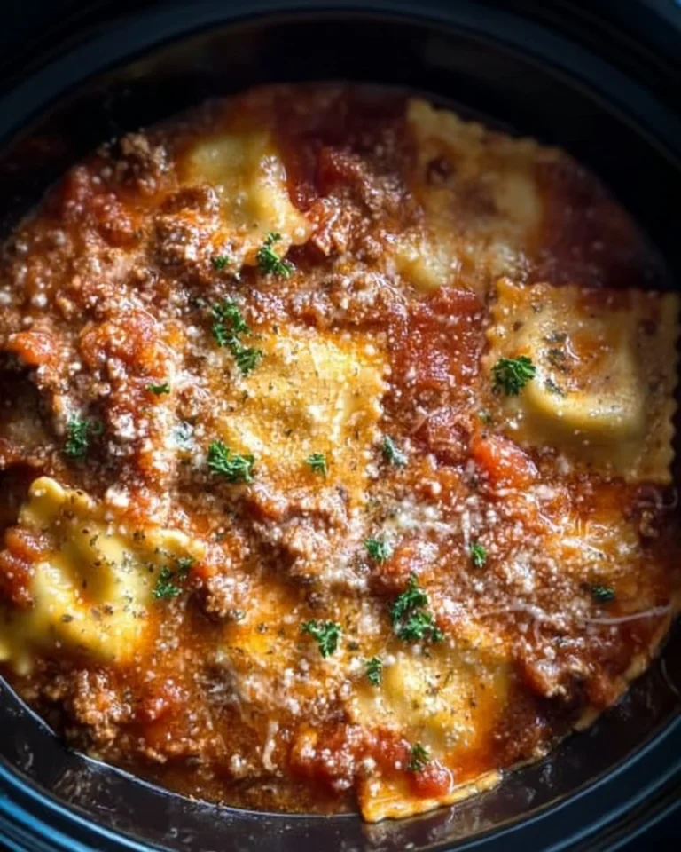 Delicious Crockpot Ravioli Lasagna served in a bowl with toppings.